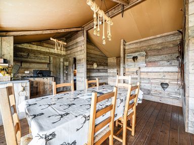 A dining room with a wooden table and chairs at Luxury Safari Lodge Sleeps 4/6 Deer Park Dogs Ok, Zeal Monachorum near Bow