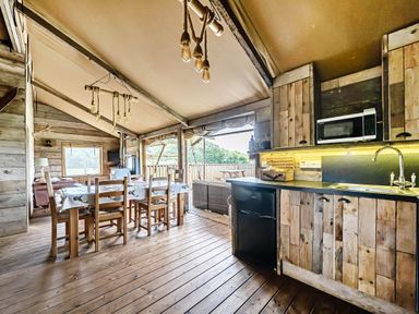 A dining area with a table and chairs at Luxury Safari Lodge Sleeps 4/6 Deer Park Dogs Ok near Zeal Monachorum