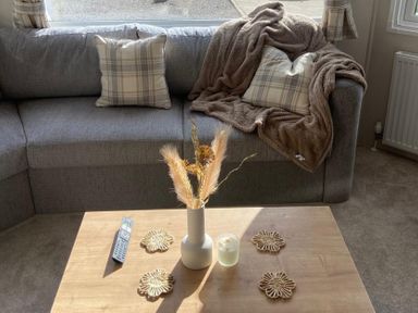 A living room with a sofa, table, and decorative items at the property