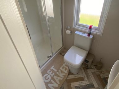 A bathroom with a shower and toilet at 