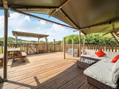 An outdoor area with seating and a table at Luxury Safari Lodge Sleeps 4/6 Deer Park Dogs Ok Zeal Monachorum near Bow