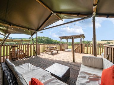 An outdoor living area with seating and picnic table at Luxury Safari Lodge Sleeps 4/6 Deer Park Dogs Ok Zeal Monachorum near Bow