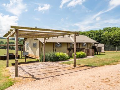 A tent with a wooden deck and pergola at Luxury Safari Lodge Sleeps 4/6 Deer Park Dogs Ok Zeal Monachorum near Bow