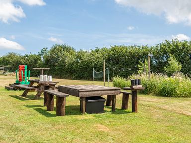 A picnic area with a wooden table and benches at Luxury Safari Lodge Sleeps 4/6 Deer Park Dogs Ok Zeal Monachorum near Bow