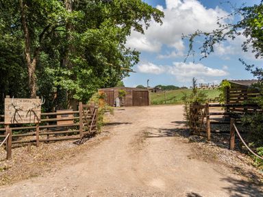 An entrance with wooden gates and a sign at Luxury Safari Lodge Sleeps 4/6 Deer Park Dogs Ok Zeal Monachorum near Bow