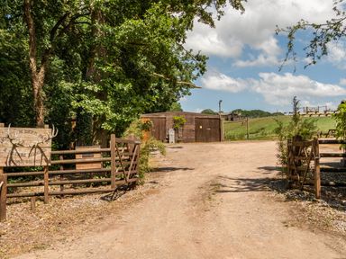 A pathway leading to a lodge with a sign at Luxury Safari Lodge Sleeps 4/6 Deer Park Dogs Ok Zeal Monachorum near Bow