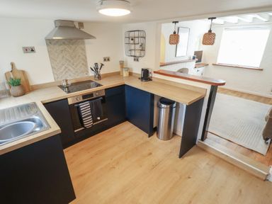 A kitchen with a cooking stove and sink at Pax Cottage 