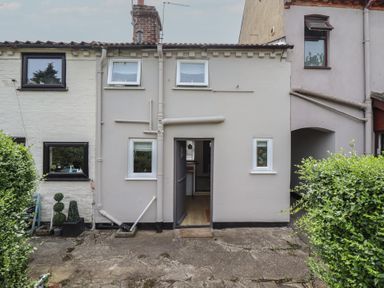 The exterior of a house with a pathway at Pax Cottage