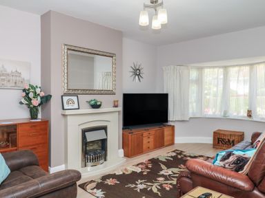A living room with a television and fireplace at 3 Heath Park Brixham