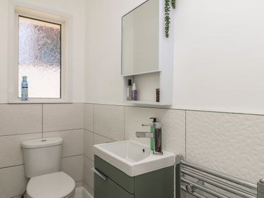 A bathroom with a toilet and sink at 3 Heath Park Brixham