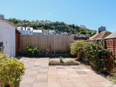 A garden with paving stones, fence and plants at 3 Heath Park in Brixham