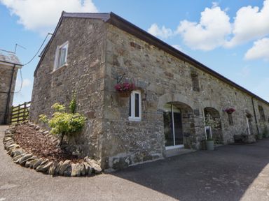 A stone building with windows and a door at The Cart House in Pontsian