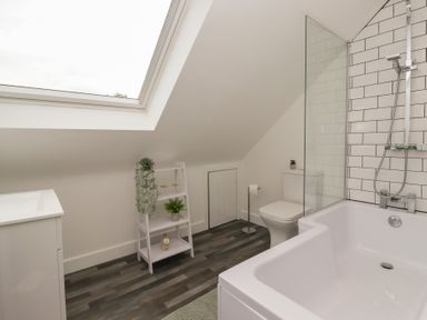 A bathroom with a bathtub and a toilet at Fields view in Bridlington
