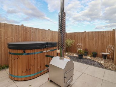 An outdoor area featuring a hot tub and stove at Fields View in Fraisthorpe