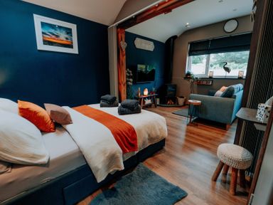 A bedroom with a bed and a sofa at TyCosy St Davids