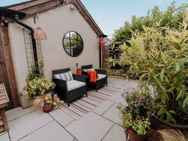 An outdoor seating area with chairs and a table at TyCosy St Davids