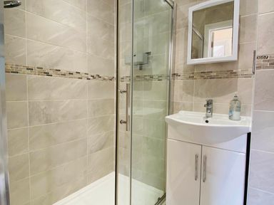 A bathroom with a shower and sink at Rivercrest in Looe