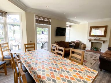 A dining room with a table and chairs at Nesden House 
