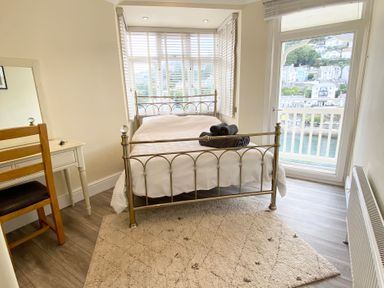 A bedroom with a bed and towels on top at Nesden House 