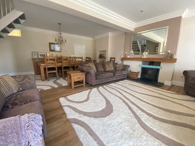 A living room with a dining area and furniture at Harbour Lodge in Looe