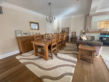 A dining room with a table and chairs at Harbour Lodge in Looe