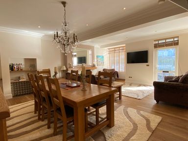 A dining room with a table and chairs at Harbour Lodge in Looe