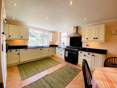 A kitchen with cabinets and appliances at Harbour Lodge in Looe