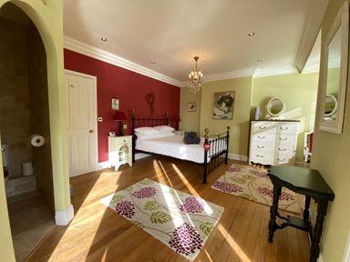 A bedroom with a bed and nightstand at Harbour Lodge in Looe