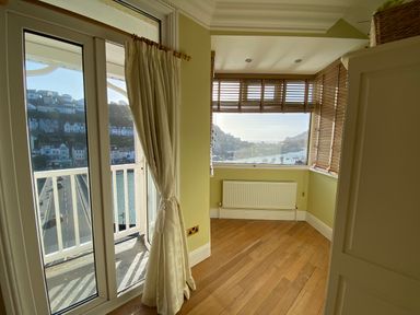 A room with a window and curtains at Harbour Lodge in Looe