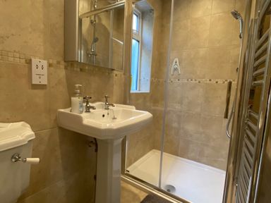 A bathroom with sink, toilet, and shower at Harbour Lodge in Looe