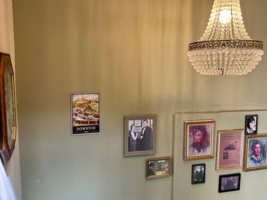 A staircase with wall art and a chandelier at Downton II in Alnwick
