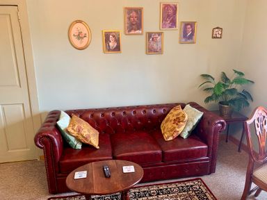 A sitting room with a sofa and wall art at Downton II in Alnwick