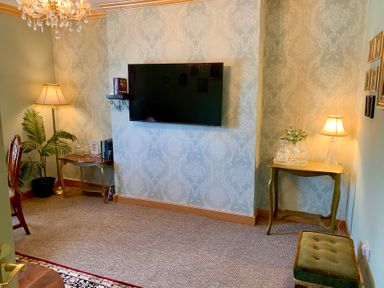 A living room with a television and lamp at Downton II in Alnwick