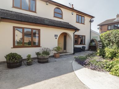 A house exterior with plants and path at Ty Traeth in Porthcawl