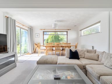 A dining room with a sofa and television at Sleeps 9 KingBeds Family Friendly Pityme near Penmayne