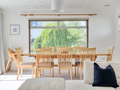 A dining room with a table and chairs at Sleeps 9 KingBeds Family Friendly in Pityme near Penmayne