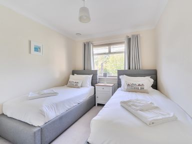 A bedroom with two beds and a window at Sleeps 9 KingBeds Family Friendly, Pityme near Penmayne