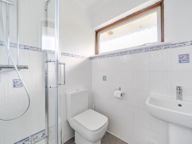A bathroom with shower, toilet, and sink at Sleeps 9 KingBeds Family Friendly in Pityme near Penmayne