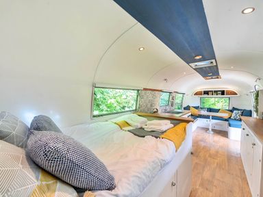 A living area with a bed and kitchenette in an accommodation at Sleeps 2 - Private Hot Tub - Fire Pit, St. Dogmaels near Cardigan