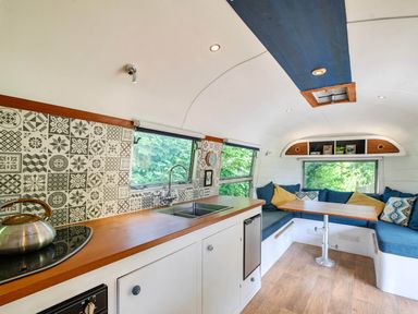A living area with a kitchen and seating area at Sleeps 2 - Private Hot Tub - Fire Pit, St. Dogmaels near Cardigan