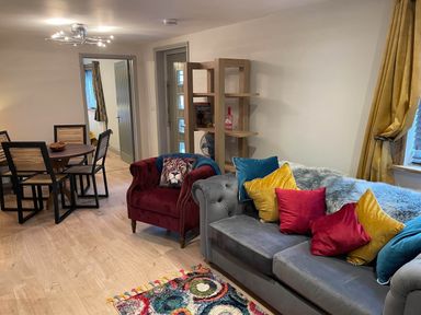 A living room with a sofa and dining area at Luxury 2 bedroom Lodge in rural lincolnshire, Kirton