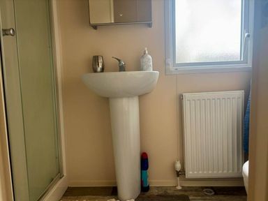 A bathroom with a sink and mirror at Caravan in Holcot Sleeps 6 Max 6 people Max 4 adults per booking Pet Friendly Holcot near Moulton
