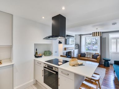 A kitchen with a loaf of bread and wine at Looe Cottage Seaside views log fire sleeps 4 in Looe