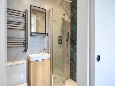A bathroom with a shower, sink, and toilet at Looe Cottage Seaside views log fire sleeps 4 in Looe