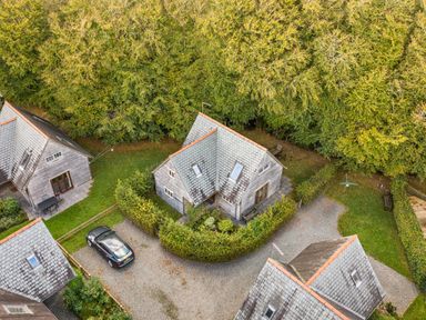 An aerial view of houses and a car at Cabin Sleeps 6 with Parking and Patio Tremail near Camelford