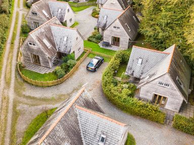 An aerial view of multiple houses with a car parked at Cabin Sleeps 6 with Parking and Patio, Tremail near Camelford