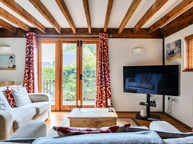 A living room with a television and a coffee table at Cabin Sleeps 6 with Parking and Patio in Tremail near Camelford
