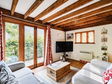A living room with a coffee table and television at Cabin Sleeps 6 with Parking and Patio, Tremail near Camelford