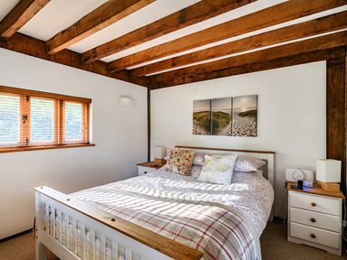 A bedroom with a bed and window at Cabin Sleeps 6 with Parking and Patio Tremail near Camelford