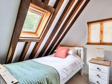 A bedroom with a single bed and window at Cabin Sleeps 6 with Parking and Patio Tremail near Camelford